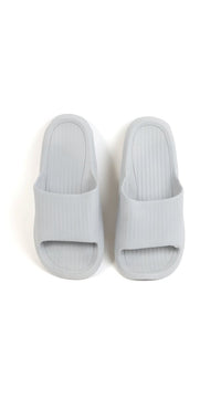 Light gray bathroom slippers with molded footbed and ribbed upper openings