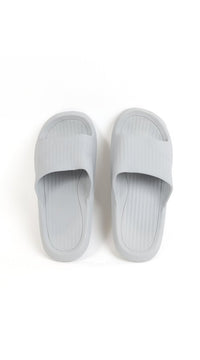 Light gray bathroom slippers with ribbed slide footbeds and open toe openings