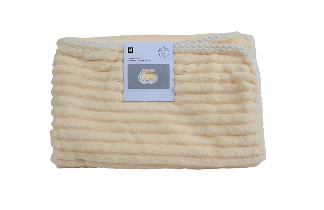 Soft cotton towel in beige, folded with textured ribbed stripes and stitched edge.