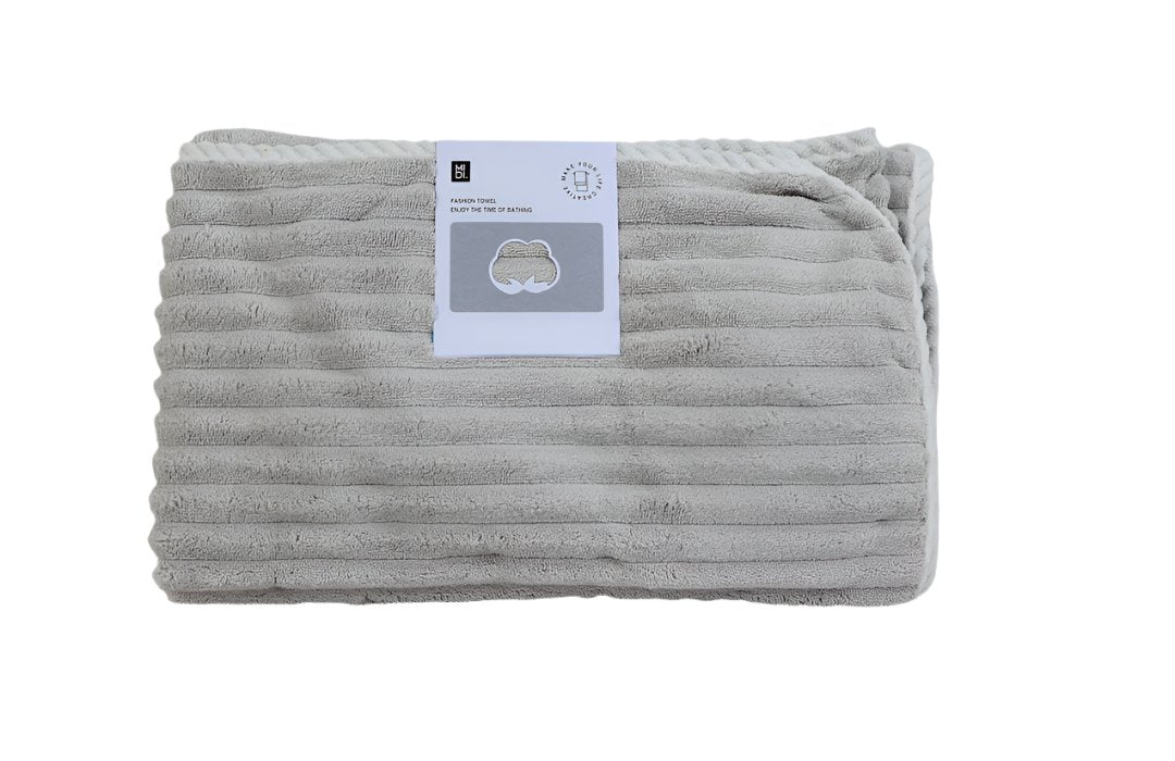 Soft cotton towel in gray, folded with textured ribbed stripes and stitched edge.