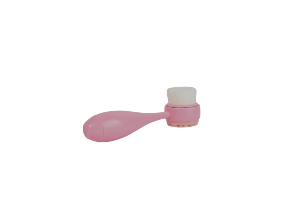 Pink face cleansing brush with soft rectangular bristle head and short handle