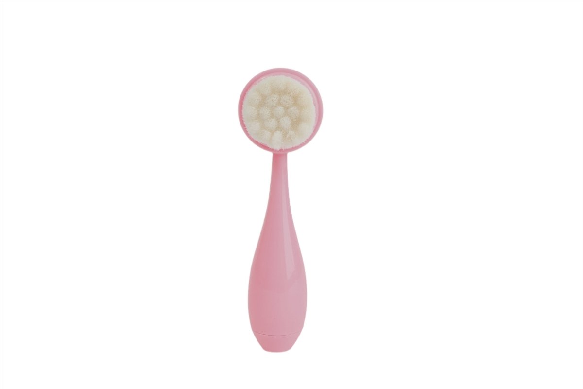 Pink silicone face cleansing brush with soft round bristles and teardrop handle