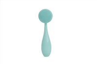 Mint face cleansing brush with circular silicone bristles and curved handle