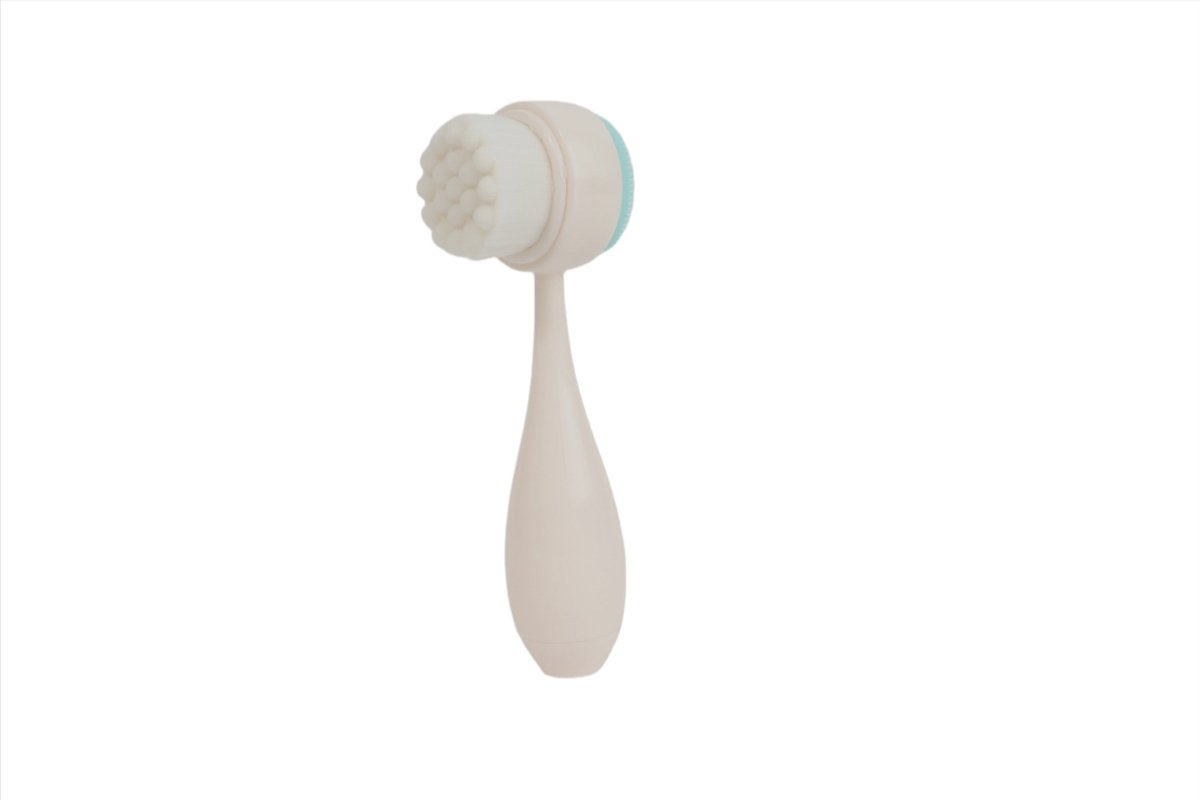 White face cleansing brush with round silicone bristle head and teardrop handle