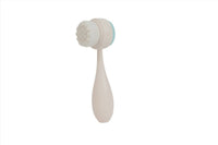White face cleansing brush with round silicone bristle head and teardrop handle