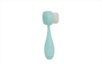 Teal face cleansing brush with textured bristle head and teardrop handle