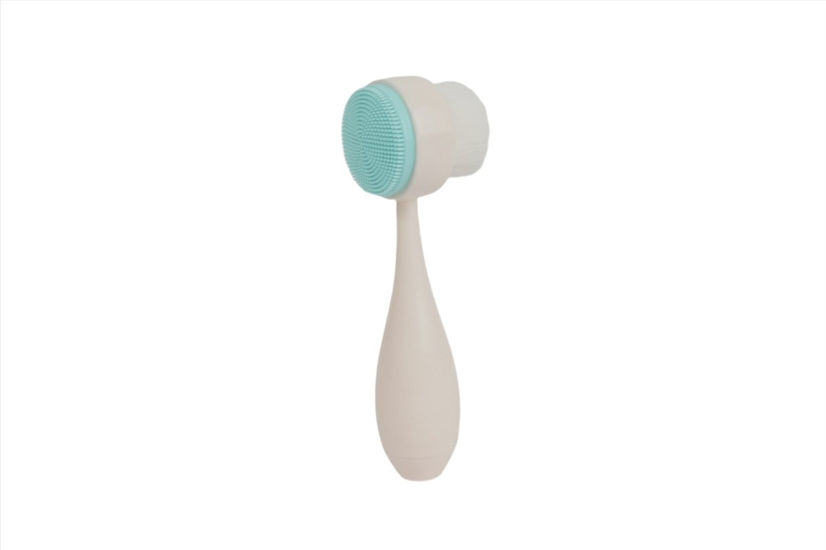 Light teal face cleansing brush with soft round bristles and curved handle