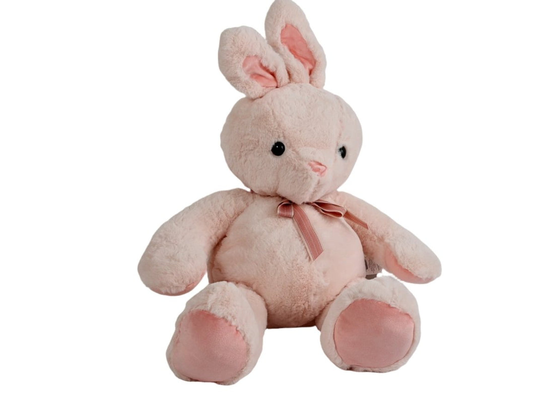Plush bunny toy sitting, pale pink plush, pink inner ears, satin bow at neck