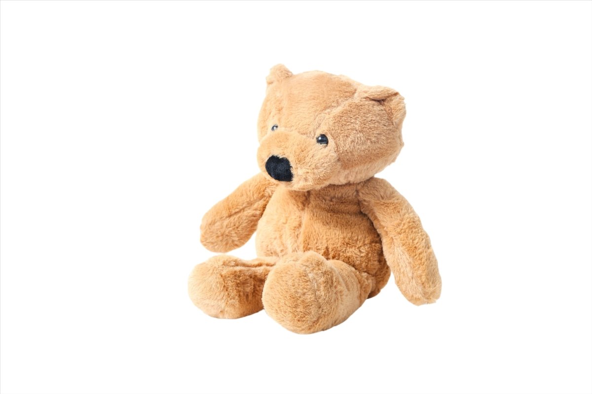 Plush teddy bear in light tan with black nose and stitched eyes, sitting pose