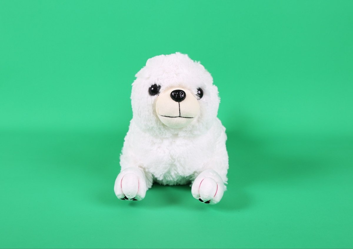 White plush puppy toy sitting upright, round face with black eyes and nose
