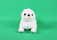 White plush puppy toy sitting upright, round face with black eyes and nose