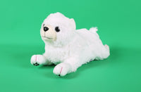 White plush puppy toy with black eyes and nose, lying with front paws forward