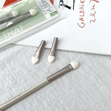 Sponge eye shadow applicator set of three with taupe handles and white sponge tips