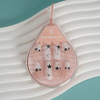 Star Design press-on nails set with sheer pink tips and black star decals