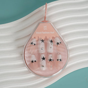 Star Design press-on nails set with sheer pink tips and black star decals