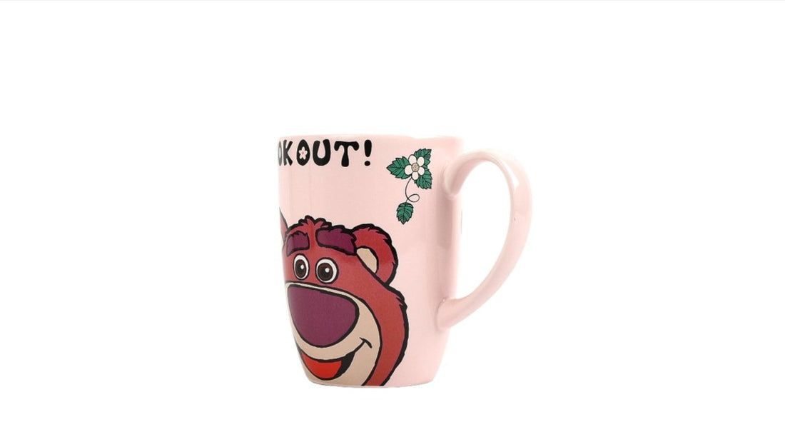 Pink ceramic kids cup with bear face and 'Look out!' text, side view