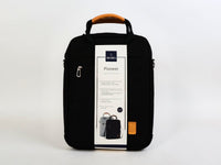 Black 13-inch laptop bag with top handle, front zip pocket, and included info card