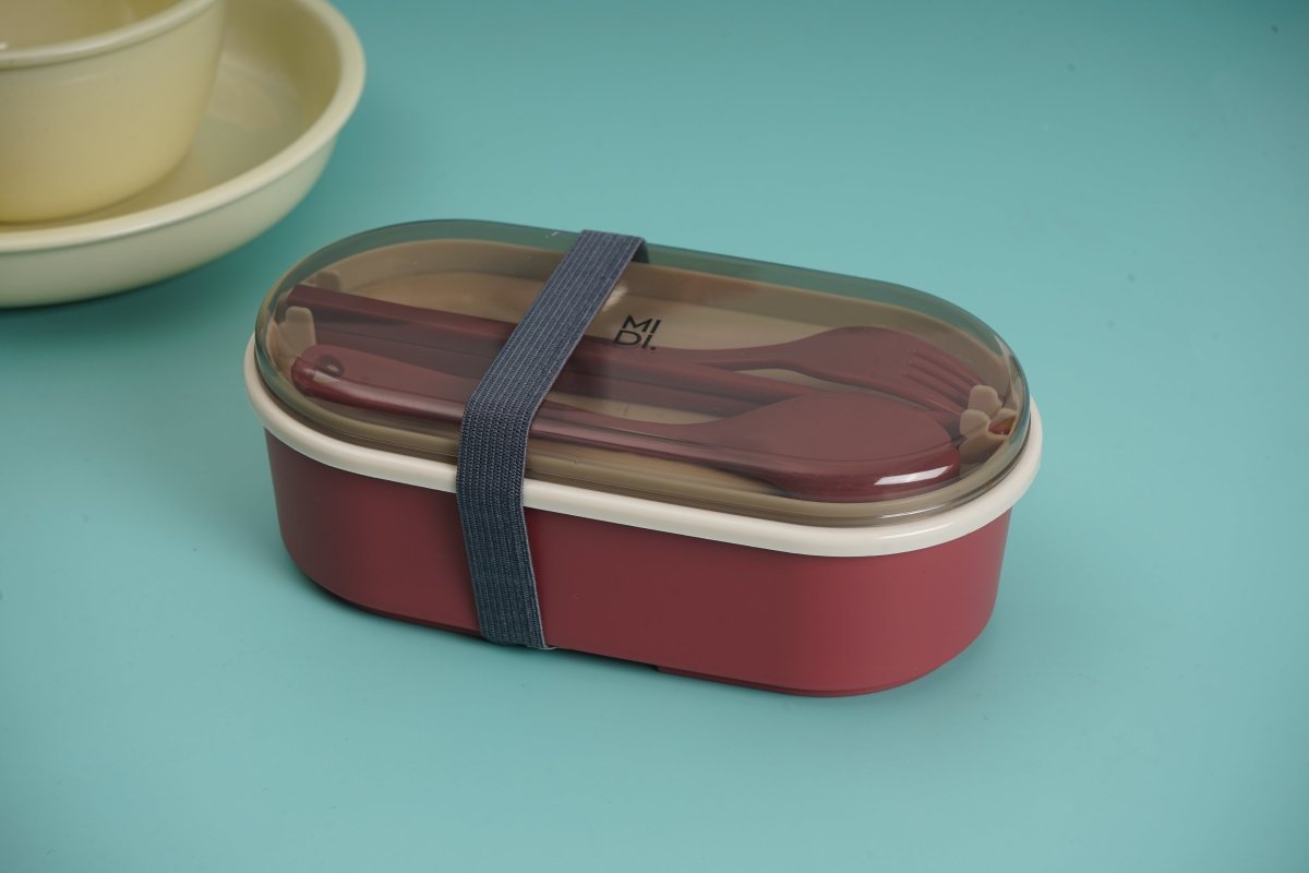Maroon bento lunch box with clear lid and integrated strap