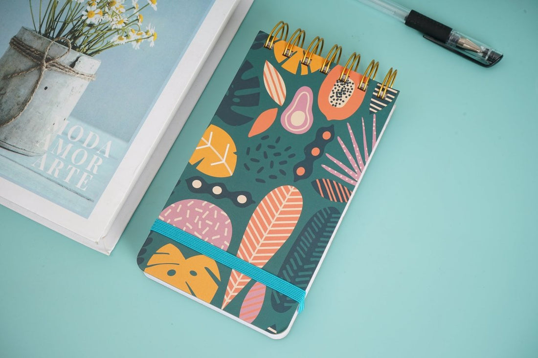 Kids spiral notebook, green cover with fun leaf print and blue ribbon band