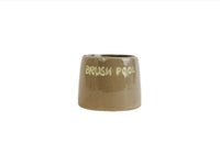 Ceramic toothbrush holder, glossy tan with raised rim and front text