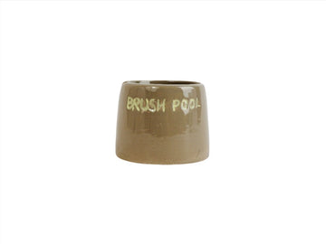 Ceramic toothbrush holder, glossy tan with raised rim and front text