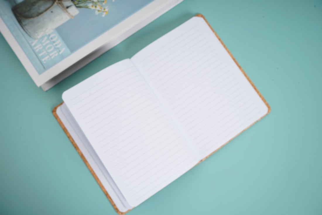 Notebook with lined pages, open book view with white ruled sheets