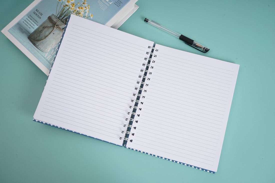 Large spiral notebook open to lined pages with metal coil binding