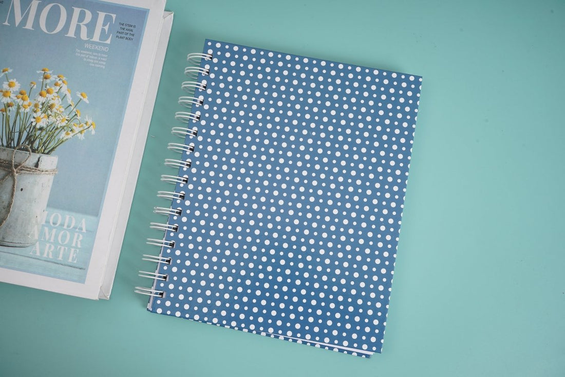 Large spiral notebook with blue dotted cover and metal rings
