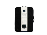 Black laptop sleeve with hanging product tag and instruction card inside sleeve.