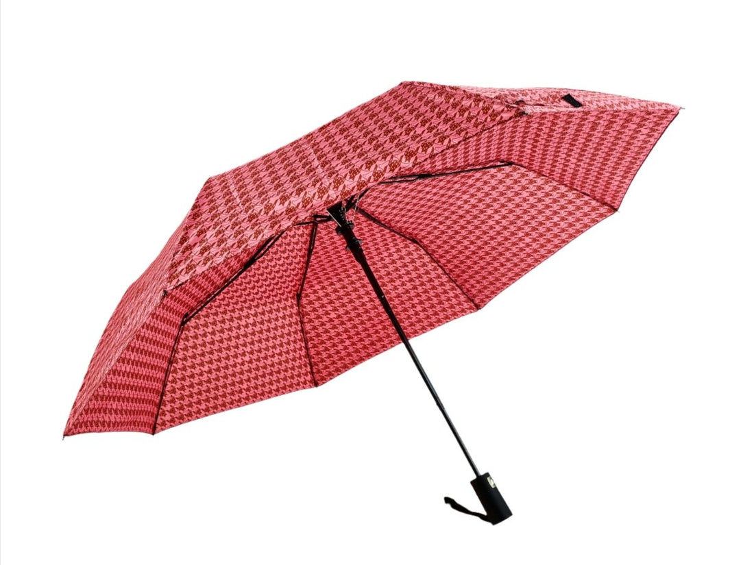 Red folding umbrella with houndstooth pattern, partially open canopy and black ribs