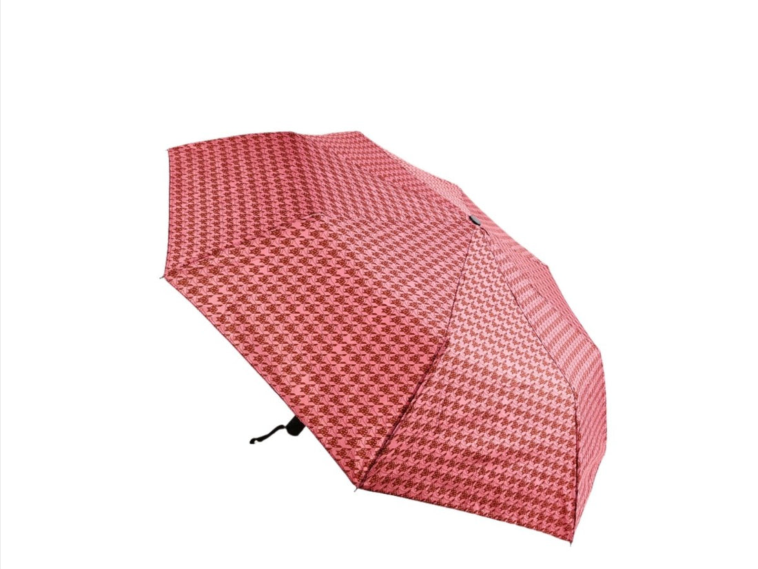 Red folding umbrella with houndstooth pattern, closed canopy and black handle