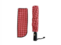 Folded red umbrella cover with houndstooth pattern, sleeve and black carrying case