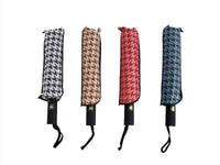 Assorted patterned folding umbrellas in black-and-white, brown, red, and blue