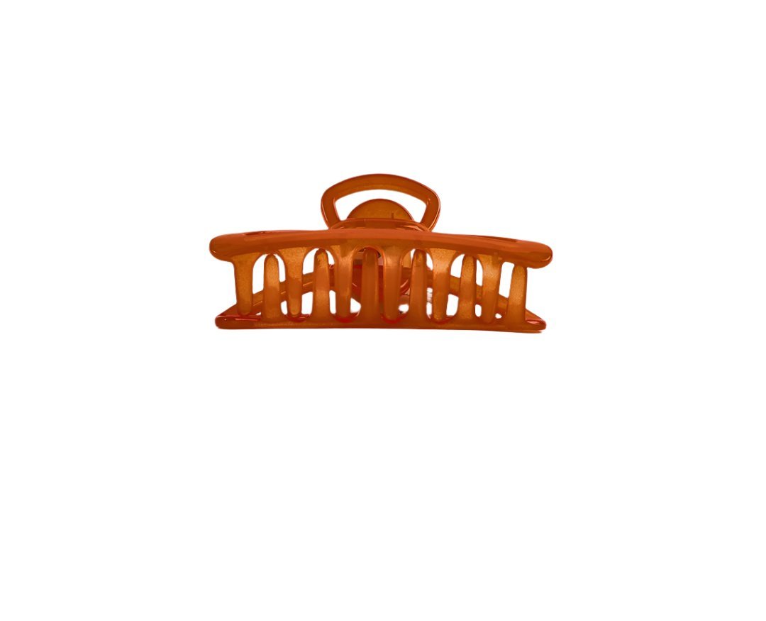 Orange plastic claw hair clip with curved top bar and teeth