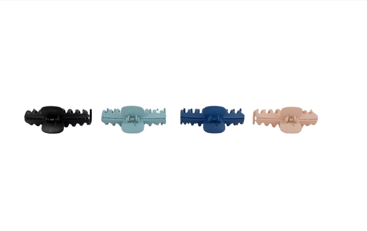 Four claw hair clips shown side by side in black, light blue, navy, beige