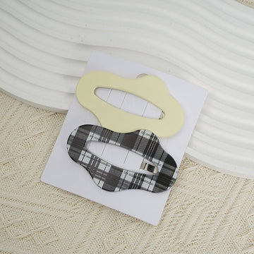 Set of hair clips with pale yellow oval and black plaid bow-style clips