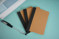 Kraft paper notebook set with brown covers and black elastic bands.