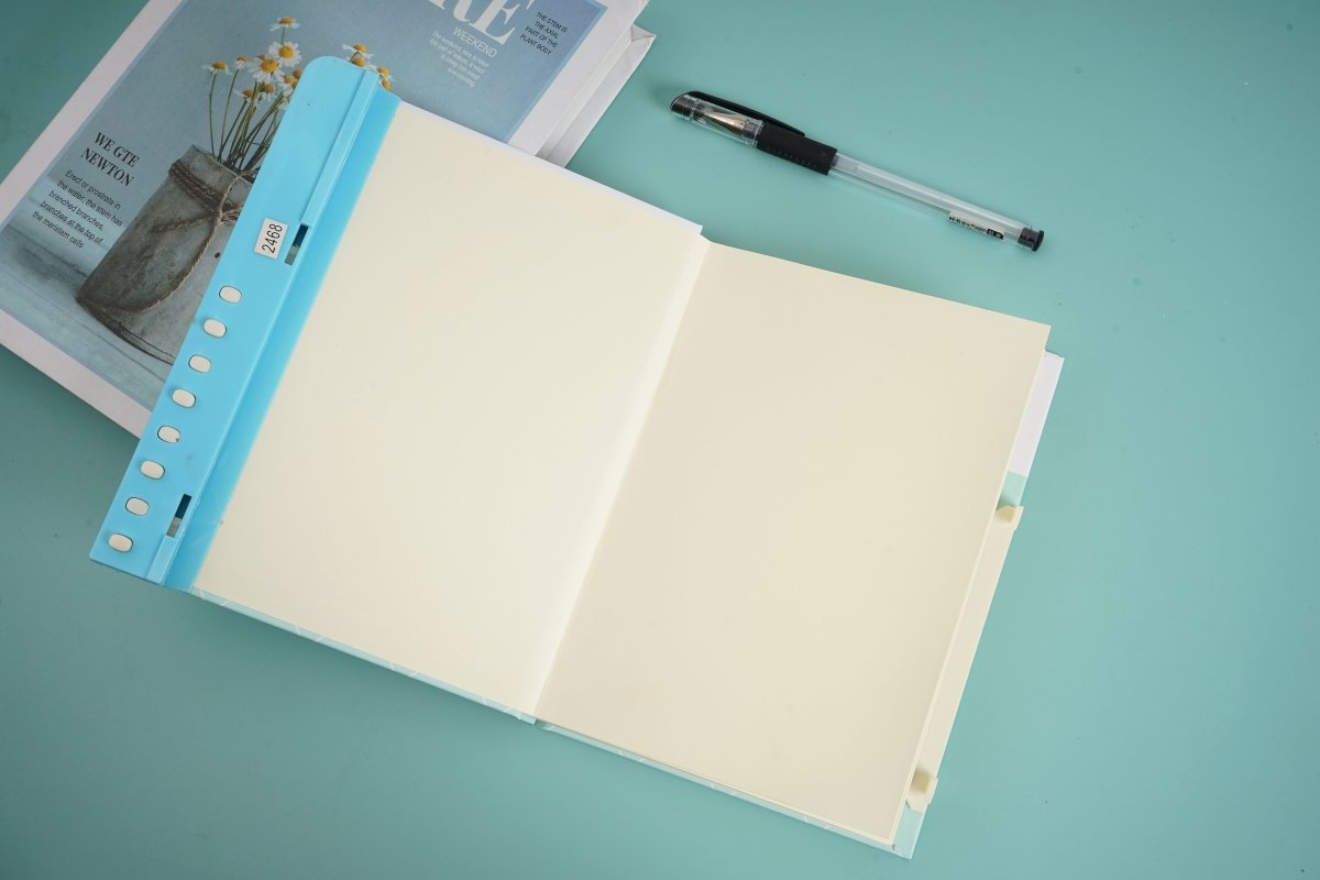 Open blue hardback notebook with blank pages and blue side tabs