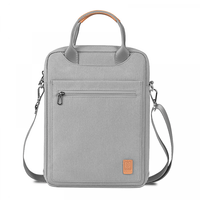 Gray laptop bag with top handle, front zip pocket, adjustable shoulder strap, logo tag