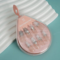 Stick-on nails with sheer nude look and mixed silver star and gem accents