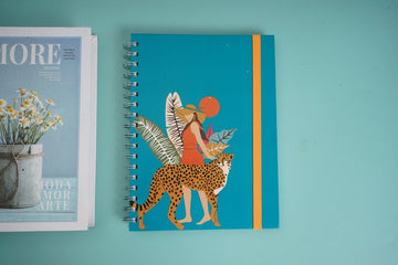 Teal coil notebook with illustrated leopard figure and orange vertical stripe on cover