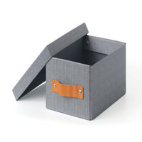Open fabric storage box with gray walls and tan leather side pull strap