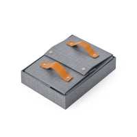 Fabric storage box with gray lid and tan leather handles, buttoned straps