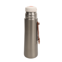 Stainless thermal water bottle with closed white lid and side carry loop