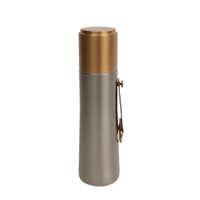 Stainless thermal water bottle with gold lid and side latch handle
