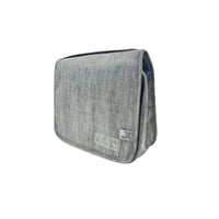 Grey travel bag with zippered side opening and icon patch on front