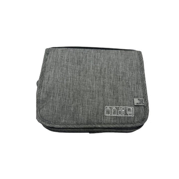 Grey travel bag with foldover flap and small front patch with icons
