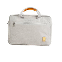 Light gray laptop bag with top handle, front zip, orange carry handle trim, and logo patch
