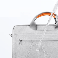 Light gray laptop bag showing front zip pocket with water spray test on zipper area