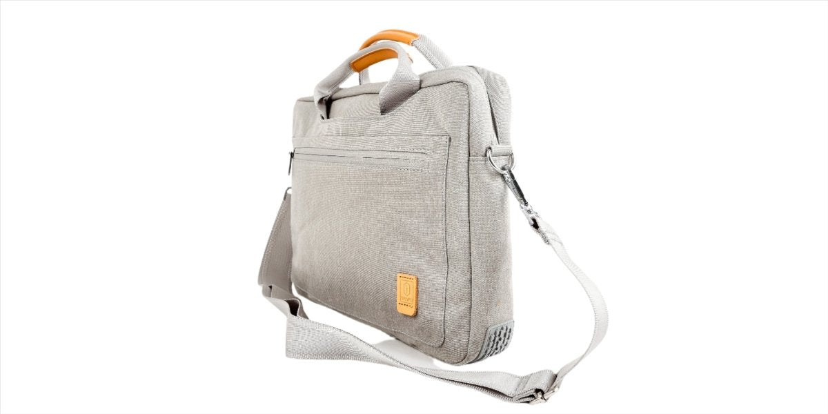 Light gray laptop bag side view with adjustable shoulder strap and orange handle trim